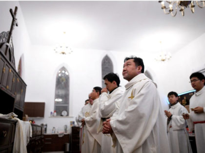 Chinese Catholic clergy prepare to attend a mass during the Christmas Eve at a Catholic church in Beijing on December 24, 2018.