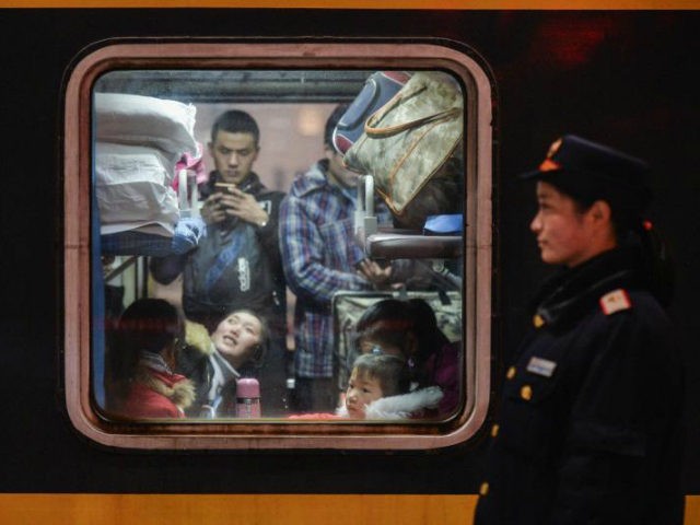 Passengers wait for a train to depart from the Hankou Railway Station in Wuhan, central Ch