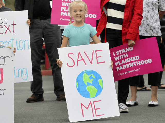 A young girl with a sign concerning global warming joined about 200 demonstrators before a town hall meeting with Republican US Representative Darrell Issa at a high school in San Juan Capistrano, California, June 3, 2017. / AFP PHOTO / Bill Wechter (Photo credit should read BILL WECHTER/AFP/Getty Images)