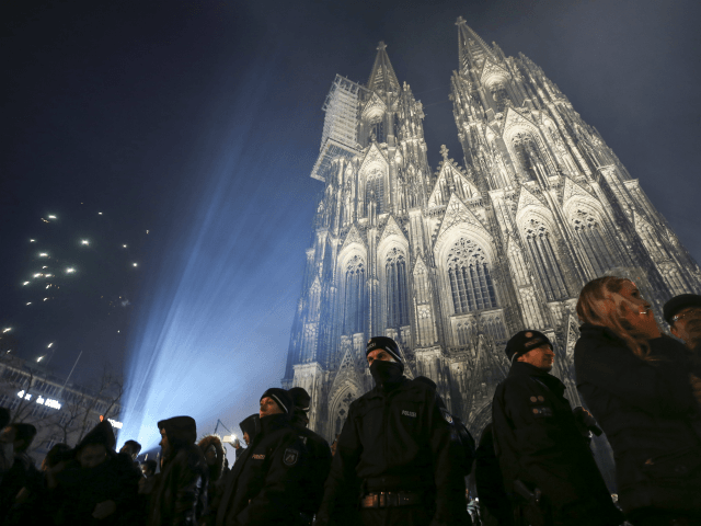 COLOGNE, GERMANY - JANUARY 1: Visitors celebrate New Year's Eve as police stand guard in front of Cologne Cathedral, not far from where on New Year's Eve one year ago hundreds of apparently coordinated sexual assaults were perpetrated against women, on January 1, 2017 in Cologne, Germany. City authorities have …