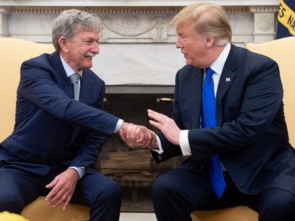 US President Donald Trump shakes hands with Danny Burch, an American who was held hostage in Yemen for 18 months, in the Oval Office of the White House in Washington, DC, March 6, 2019. (Photo by SAUL LOEB / AFP) (Photo credit should read SAUL LOEB/AFP/Getty Images)
