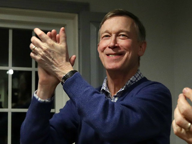 FILE - In this Feb. 13, 2019, file photo, former Colorado Gov. John Hickenlooper, left, applauds at a campaign house party, in Manchester, N.H. Hickenlooper is running for president, becoming the second governor to jump into the sprawling Democratic 2020 contest. Hickenlooper is a former brewpub owner and Denver mayor …