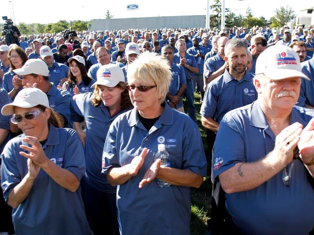 Ford employees applaud at an event that celebrates the opening of the new U.S. production