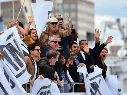 A boat carrying supporters for the Remain in the EU campaign including Bob Geldof (C) shout and wave at Brexit fishing boats as they sail up the river Thames in central London on June 15, 2016. A Brexit flotilla of fishing boats sailed up the River Thames into London today …