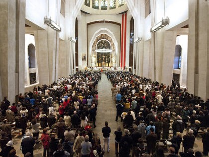 This October 17, 2010 photo worshippers during a solemn mass inside Saint Joseph's Oratory basilica in Montreal, Quebec, Canada. More than 1,000 Quebecers gathered Sunday at a Roman Catholic basilica in Montreal to watch their beloved Brother Andre enter the sainthood at the Vatican, calling it a "message of hope." …