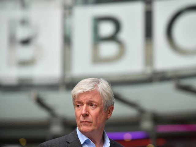 Director-General of the BBC Tony Hall is seen waiting to greet Britain's Prince William, Duke of Cambridge, and Britain's Catherine, Duchess of Cambridge, as the royal couple visit BBC Broadcasting House in London on November 15, 2018 to view the work the broadcaster is doing as a member of The …