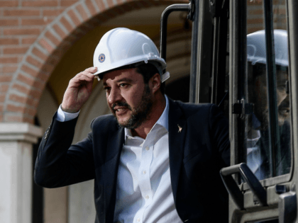 Italys Interior Minister and deputy PM Matteo Salvini stands on a bulldozer as he prepares