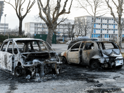 This picture taken on March 5, 2019 shows two burnt cars in the street where riots sparked