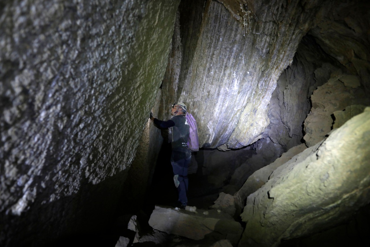 A journalist walks in the Malham cave inside Mount Sodom, located at the southern part of the Dead Sea in Israel on March 27, 2019. - Israeli spelunkers announced on March 27 that a salt cave near the Dead Sea was over ten kilometres long, beating Iran's N3 cave in Qeshm to make it the world's largest. The cave, named Malham, is a series of canyons running through Mount Sodom, Israel's largest mountain, and spilling out to the southwest corner of the adjacent Dead Sea. (Photo by MENAHEM KAHANA / AFP) (Photo credit should read MENAHEM KAHANA/AFP/Getty Images)