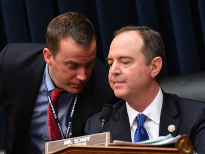 US Representative Adam Schiff (L) , Chairman of the House Permanent Select Committee on Intelligence, speaks to an aide as the committee holds a hearing on "Putin's Playbook: The Kremlin's Use of Oligarchs, Money and Intelligence in 2016 and Beyond," on March 28, 2019, in Washington DC. (Photo by MANDEL …