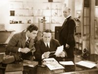 1936: American actor Jack Mulhall (1888-1979) examines a set of fingerprints in 'The Clutching Hand'. Title: The Clutching Hand Studio: Stage and Screen Director: Albert Herman (Photo by Hulton Archive/Getty Images)
