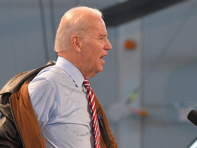 US Vice President Joe Biden takes off his military jacket before delivering a speech at the "90 Military Airbase" in Bucharest on May 20, 2014. US Vice President Joe Biden blasted Russia's annexation of Crimea, saying borders should not be changed at gunpoint, as he began a visit to Romania …