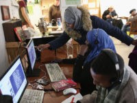 BAD BELZIG, GERMANY - OCTOBER 26: Warda Abdi (standing), 23, an asylum-seeker from Somalia, looks at a YouTube video with her friend and fellow-Somali asylum applicant Asha at the "Der Winkel" cafe where many local asylum applicants go for Internet access and company on October 26, 2015 in Bad Belzig, …