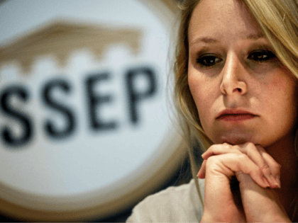French far-right politician Marion Marechal looks on next to the logo of the new 'Institut de Sciences Sociales Economiques et Politiques', ISSEP (Institute of Social, Economic and Politic Sciences) she launched on June 22, 2018, in Lyon during a press conference to inaugurate the school. (Photo by JEFF PACHOUD / …