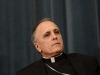 US cardinal Daniel DiNardo listens during a press conference at the North American College on March 5, 2013 in Rome. The Vatican said Tuesday that the date for the conclave to elect a new pope could be set before all cardinals have arrived in Rome, as five electors were still …