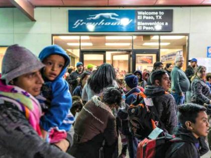 Asylum-seekers wait at a Greyhound bus station in El Paso, Texas, after being dropped off