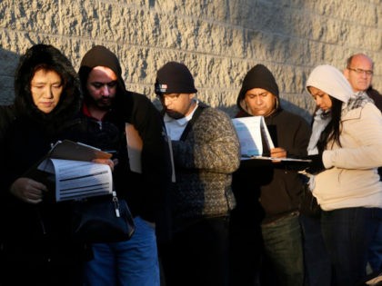 Immigrants line up after spending the night outside a California Department of Motor Vehicles office to register for drivers licenses in Stanton, Calif., Friday, Jan. 2, 2015.