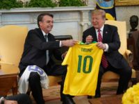 Brazilian President Jair Bolsonaro presents U.S. President Donald Trump with a Brazil national soccer team jersey Number 10 for striker position at the White House March 19, 2019 in Washington, DC. President Trump is hosting President Bolsonaro for a visit and bilateral talks at the White House today. (Photo by …