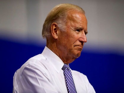 US Vice President Joe Biden listens as Democratic Presidential candidate Hillary Clinton delivers remarks at Riverfront Sports athletic facility on August 15, 2016 in Scranton, Pennsylvania. Hillary Clinton focused her speech on the economy and bringing jobs to the key swing state of Pennsylvania.