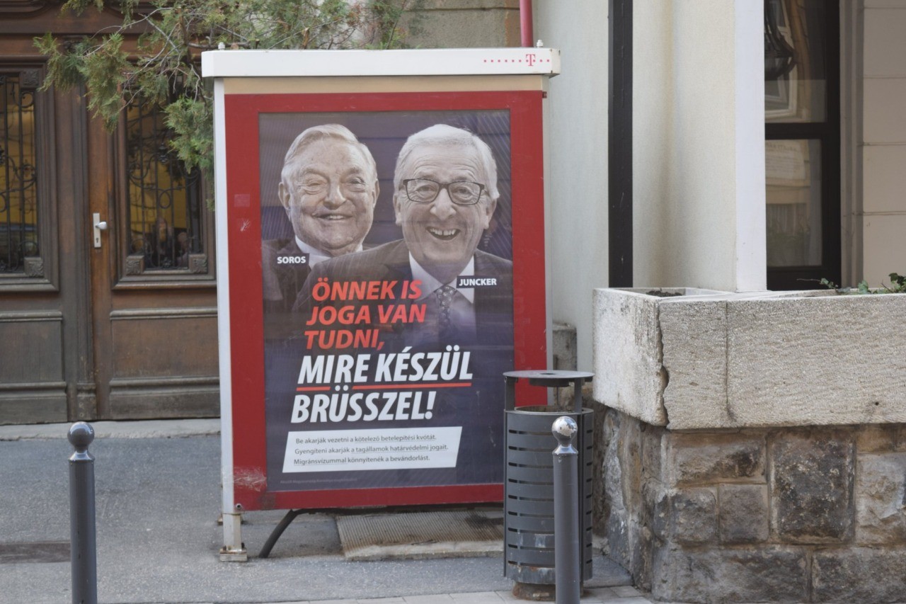A poster from a Hungarian government campaign showing EU Commission President Jean-Claude Juncker and Hungarian-American financier George Soros with the caption "You, too, have a right to know what Brussels is preparing to do" is displayed on a phone booth in Budapest, March 4, 2019. Hungarian officials said the campaign claiming that EU leaders like Juncker, backed by Soros, want to bring mass migration into Europe, would end by March 15. (AP Photo/Pablo Gorondi)