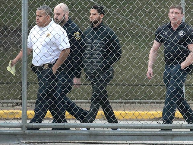 CHICAGO, ILLINOIS - FEBRUARY 21: Guards walk with Empire actor Jussie Smollett before he i