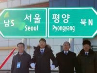 KAESONG, NORTH KOREA - DECEMBER 26: Officials from South and North Korea stand in front of a road sign during the ceremony for a project to modernize and connect roads and railways over the border between the Koreas at Panmun Station on December 26, 2018 in Kaesong, North Korea. South …