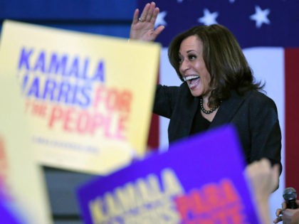 U.S. Sen. Kamala Harris (D-CA) waves as she is introduced at a town hall meeting at Canyon