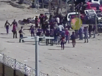 A large group of Central American migrants exploit outdated border barriers with the aid of a human smuggler to illegally enter the U.S. (Photo: U.S. Border Patrol video screenshot)