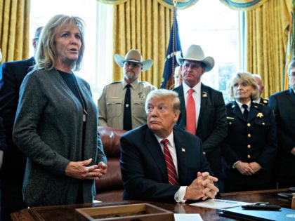 President Donald Trump listens as Mary Ann Mendoza, an "Angel Mom" who lost her son Brandon when he was killed by a drunk driver that was an undocumented immigrant, speaks before he signs the first veto of his presidency in the Oval Office of the White House, Friday, March 15, …