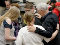 Vice President Mike Pence, right, prays with members of a family from Fremont, Neb., who were displaced by the recent floods, at a shelter in the Elkhorn Middle School, in Omaha, Neb., Tuesday, March 19, 2019. (AP Photo/Nati Harnik)