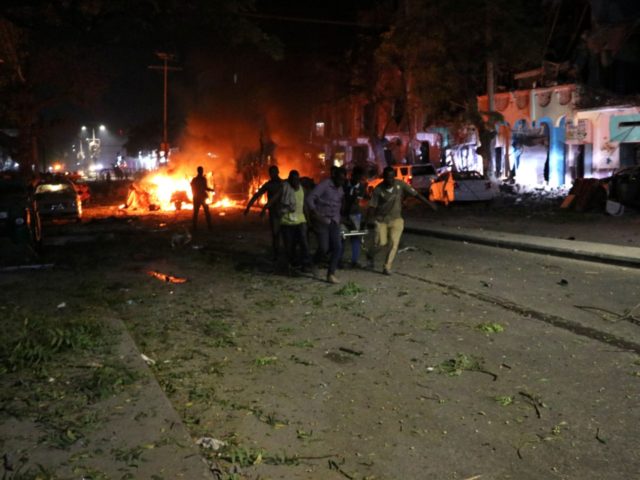 Rescuers run as they carry a stretcher in Mogadishu, the capital of Somalia, on February 2