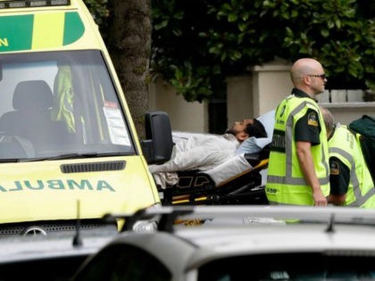 Ambulance staff take a man from outside a mosque in central Christchurch, New Zealand, Friday, March 15, 2019. A witness says many people have been killed in a mass shooting at a mosque in the New Zealand city of Christchurch. (AP Photo/Mark Baker)