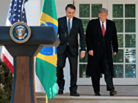 President Donald Trump and Brazilian President Jair Bolsonaro arrive for a news conference in the Rose Garden of the White House