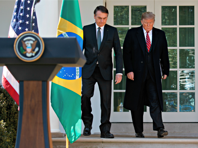 President Donald Trump and Brazilian President Jair Bolsonaro arrive for a news conference in the Rose Garden of the White House, Tuesday, March 19, 2019.. (AP Photo/Evan Vucci)