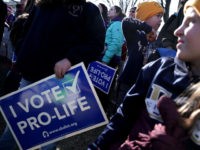 Pro-life activists participate in a rally at the National Mall prior to the 2018 March for Life January 19, 2018 in Washington, DC. Activists gathered in the nation's capital for the annual event to protest the anniversary of the Supreme Court Roe v. Wade ruling that legalized abortion in 1973. …