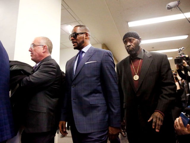 Second from left, singer R. Kelly arrives at the Daley Center for his hearing, on March 6,