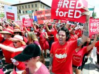 PHOENIX, AZ - APRIL 26: Thousands of Arizona teachers march through downtown Phoenix on their way to the State Capitol as part of a rally for the #REDforED movement on April 26, 2018 in Phoenix, Arizona. Teachers state-wide staged a walkout strike on Thursday in support of better wages and …