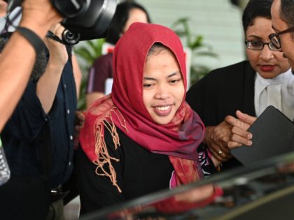 Indonesian national Siti Aisyah (C) smiles while leaving the Shah Alam High Court, outside