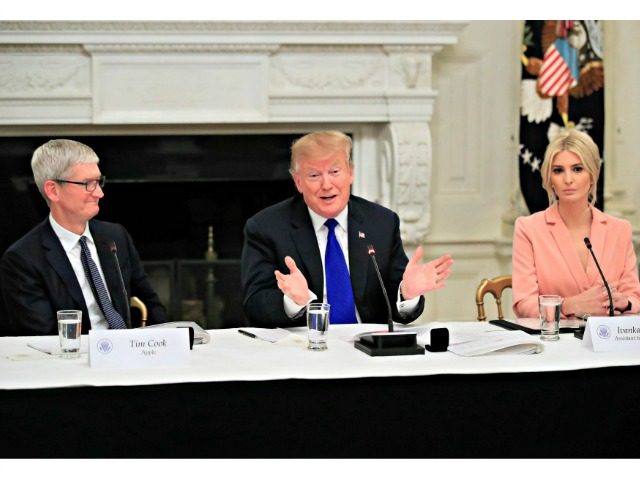 President Donald Trump with American Workforce Policy Advisory Board co-chair Ivanka Trump, right, and Apple Inc. CEO Tim Cook, left, speaks during the advisory board's first meeting in the State Dining Room of the White House in Washington, Wednesday, March 6, 2019. (AP Photo/Manuel Balce Ceneta)