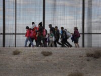 EL PASO, TEXAS - FEBRUARY 01: Central American immigrants walk along the border fence after crossing the Rio Grande from Mexico on February 01, 2019 in El Paso, Texas. The migrants later turned themselves in to U.S. Border Patrol agents, seeking political asylum in the United States. (Photo by John …
