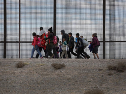 EL PASO, TEXAS - FEBRUARY 01: Central American immigrants walk along the border fence after crossing the Rio Grande from Mexico on February 01, 2019 in El Paso, Texas. The migrants later turned themselves in to U.S. Border Patrol agents, seeking political asylum in the United States. (Photo by John …
