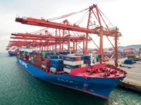 A cargo ship is seen at a port in Qingdao in China's eastern Shandong province on December 8, 2018. - China's export growth slowed last month weighed down by slowing global demand and trade tensions with the United States, official data released on December 8 showed.