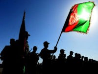 TOPSHOT - Afghan National Army (ANA) soldiers stand to attention during a ceremony at the military base in Herat on July 3, 2016. Around 1000 soldiers trained for 10 weeks during the ANA training progam, after which they are sent on assignments throughout the restive country. / AFP / AREF …