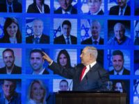 RAMAT GAN, ISRAEL - MARCH 04: Israel's Prime Minster Benjamin Netanyahu points to photos of Likud party members as he delivers a speech during the launch of the Likud party election campaign on March 4, 2019 in Ramat Gan, Israel. (Photo by Amir Levy/Getty Images)