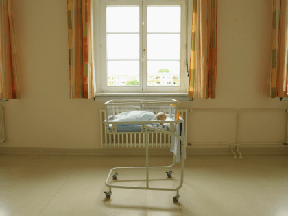 UNDISCLOSED, GERMANY - AUGUST 12: A 4-day-old newborn baby, who has been placed under a window by the photographer, lies in a baby bed in the maternity ward of a hospital (a spokesperson for the hospital asked that the hospital not be named) on August 12, 2011 in a city …