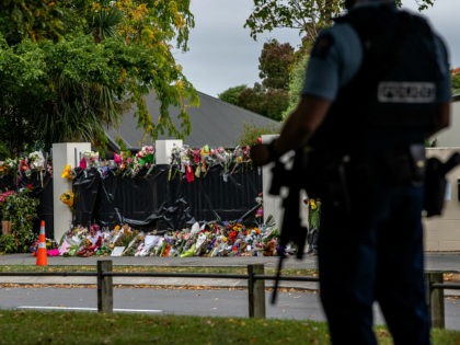 CHRISTCHURCH, NEW ZEALAND - MARCH 21: Flowers lie by the wall of Al Noor mosque as an armed policeman guards nearby on March 21, 2019 in Christchurch, New Zealand. 50 people were killed, and dozens are still injured in hospital after a gunman opened fire on two Christchurch mosques on …