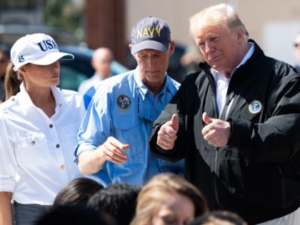 US President Donald Trump Florida Governor Rick Scott and First Lady Melania Trump hand out bottles of water as they tour damage from Hurricane Michael in Lynn Haven, Florida, October 15, 2018. - President Donald Trump visited Florida on Monday, nearly a week after Hurricane Michael slammed the southern US …