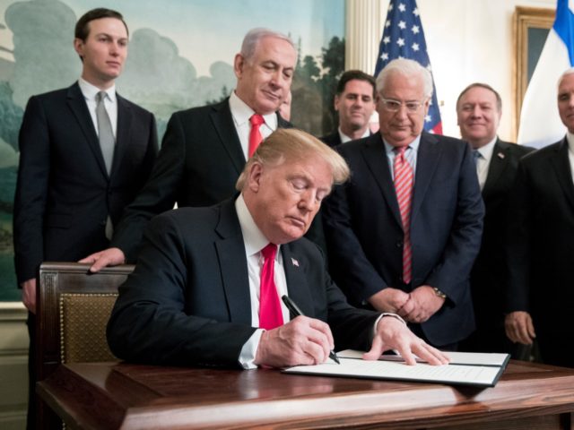 WASHINGTON, DC - MARCH 25: (AFP OUT) US President Donald J. Trump (C) signs an order recog