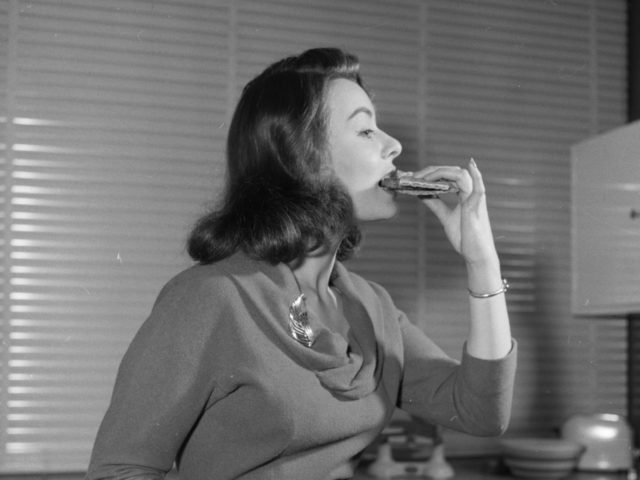 April 1958: British film actress Anne Heywood tasting a low calorie vegetarian hamburger m