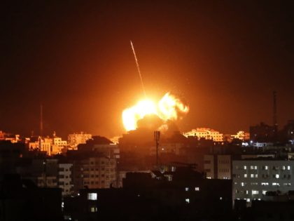 TOPSHOT - A ball of fire lights the sky above a building believed to house the offices of Hamas chief in Gaza, Ismail Haniyeh, during Israeli strikes on the Gaza City, on March 25, 2019. - Israel's military launched strikes on Hamas targets in the Gaza Strip today, the army …